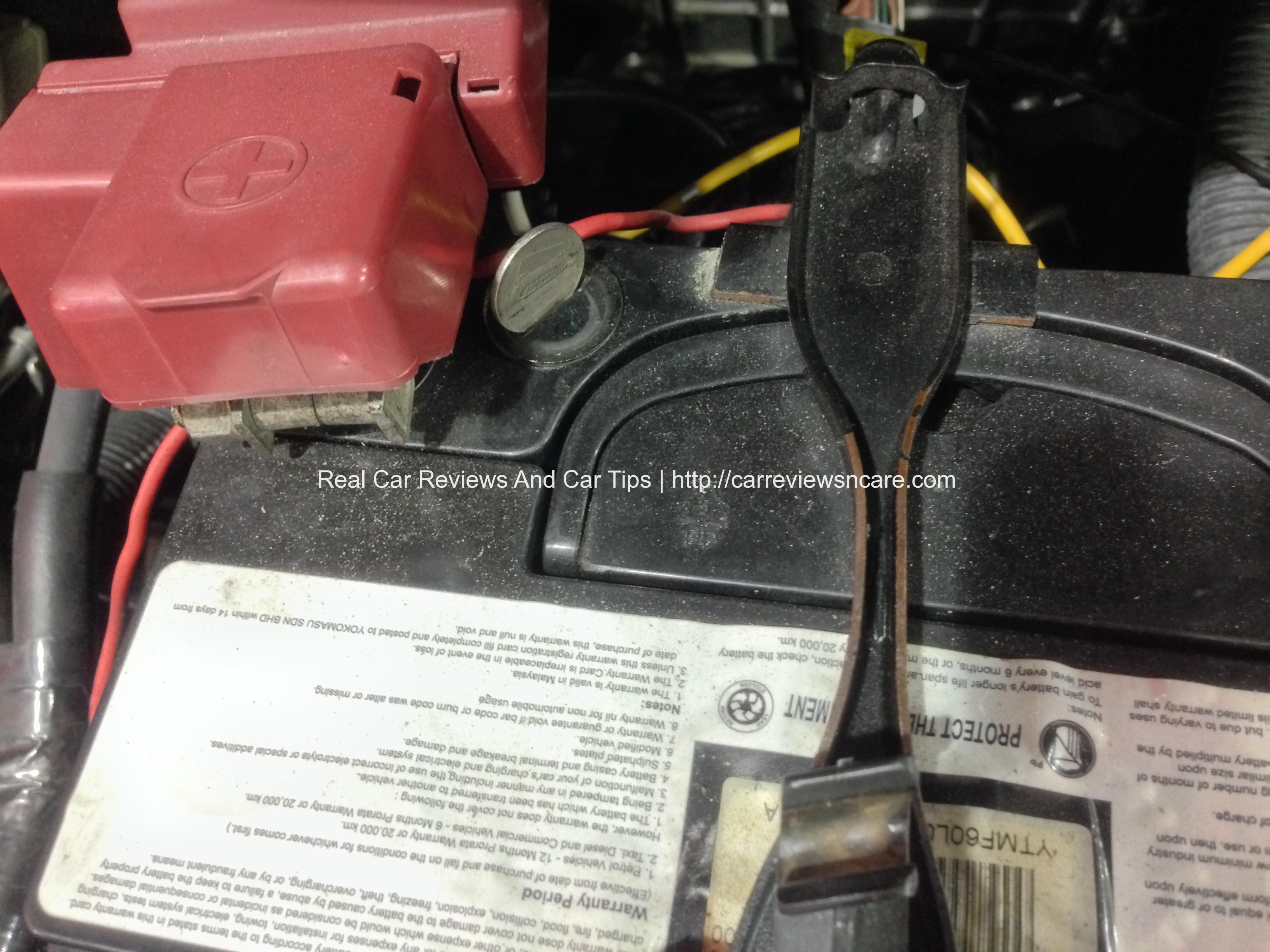 Topping up your old style car battery with distilled water t