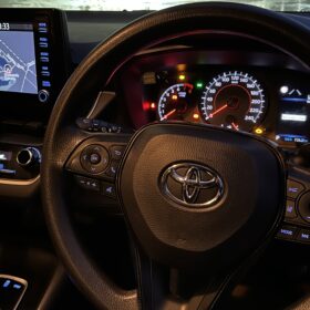 Toyota right-hand-drive cockpit with illuminated instrument cluster and navigation screen